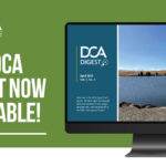 The image is a promotional graphic on a green background featuring the announcement of a new publication for the Delta Conveyance Design and Construction Authority (DCA). On the left side of the image, in bold white text, it reads, "NEW DCA DIGEST NOW AVAILABLE!" Above this message are the DCA logo and name. On the right, there is an image of a computer screen displaying the DCA Digest cover, which is split into two sections. The left section includes the DCA logo, the title "DCA DIGEST," and a detailed description of the publication, set against a blue background. The right section displays a scenic photograph of a serene lake with wind turbines on the distant hills against a clear blue sky. The DCA logo appears again in the upper right corner of the monitor image.